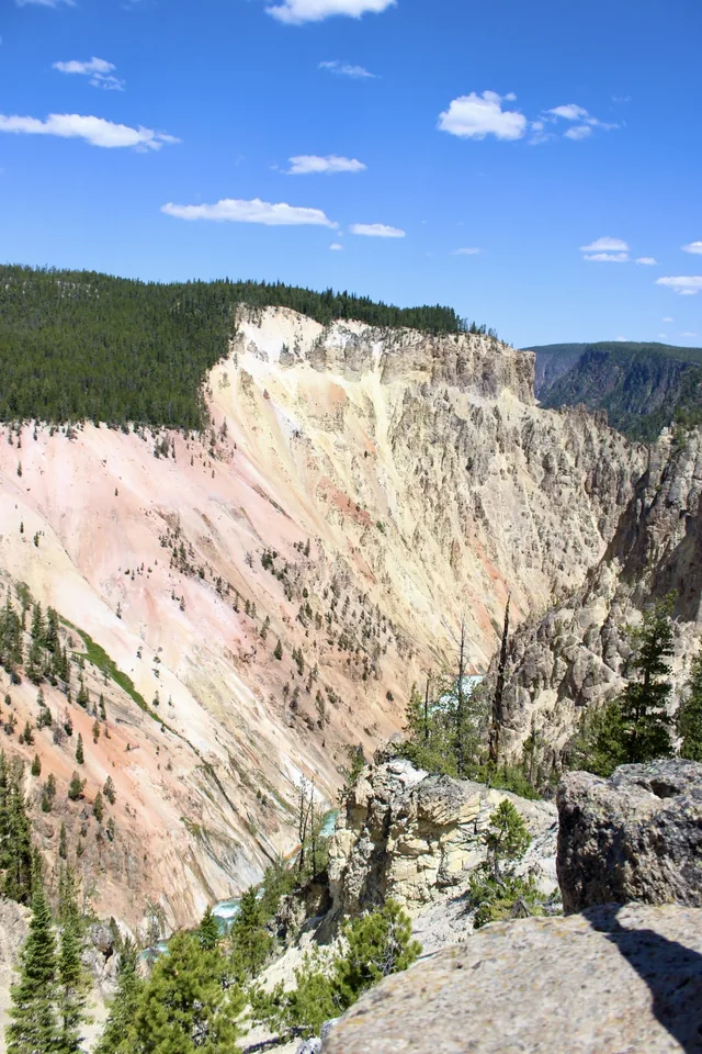 A pale canyon ridge beneath an open blue sky